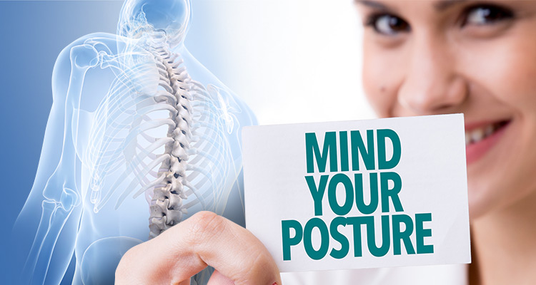 Woman holding a card that says Mind Your Posture in front of a figure showing the human spine 