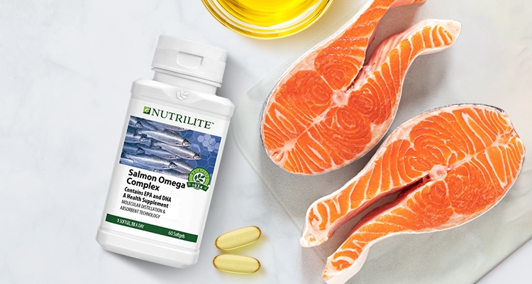 Stylised image of Nutrilite Salmon Omega Complex with softgels and salmon 